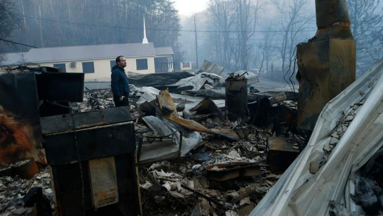 GATLINBURG, TN - NOVEMBER 29:  Trevor Cates, walks through the smoldering remains of the fellowship hall of his church, the Banner Missionary Baptist Church as he inspects damage after a widfire November 29, 2016 in Gatlinburg, Tennessee. Thousands of people have been evacuated from the area and over 100 houses and businesses were damaged or destroyed. Drought conditions and high winds helped the fire spread through the foothills of the Great Smoky Mountains. (Photo by Brian Blanco/Getty Images)