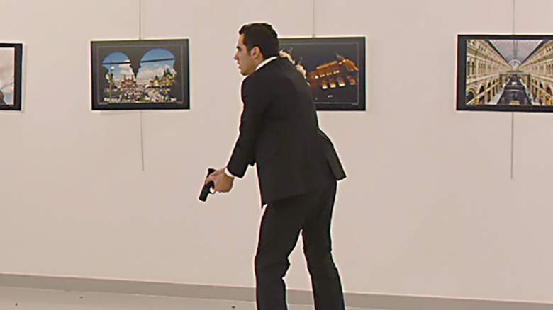 TOPSHOT - This picture taken on December 19, 2016 shows Andrey Karlov (L), the Russian ambassador to Ankara, lying on the floor after being shot by a gunman (R) during an attack during a public event in Ankara. A gunman crying "Aleppo" and "revenge" shot Karlov while he was visiting an art exhibition in Ankara on December 19, witnesses and media reports said. The Turkish state-run Anadolu news agency said the gunman had been "neutralised" in a police operation, without giving further details. / AFP / Sozcu daily / Yavuz Alatan / Turkey OUT (Photo credit should read YAVUZ ALATAN/AFP/Getty Images)