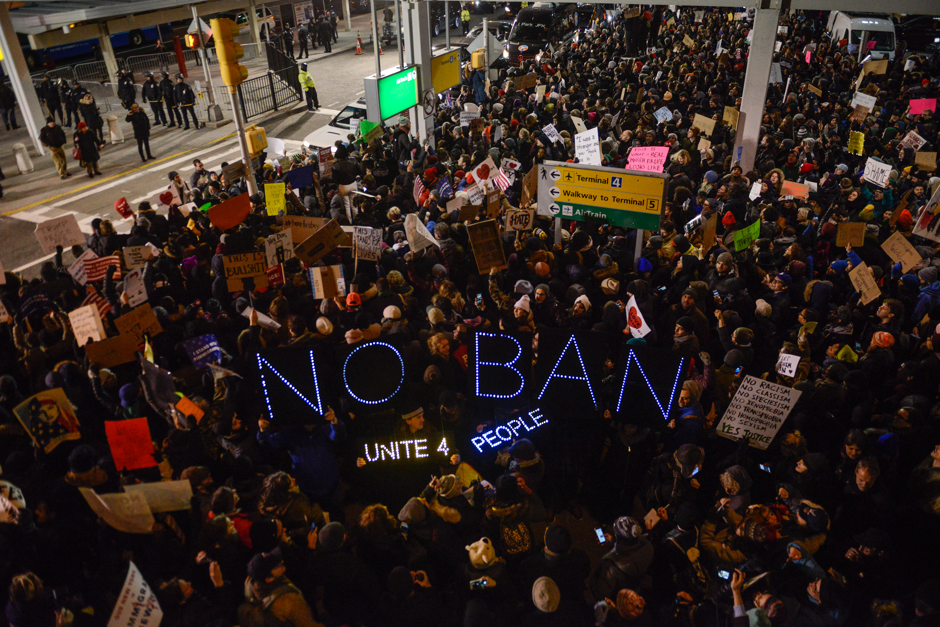 Protestors rally during a demonstration against the Muslim immigration ban at JFK airport January 28 in New York City. (Getty)