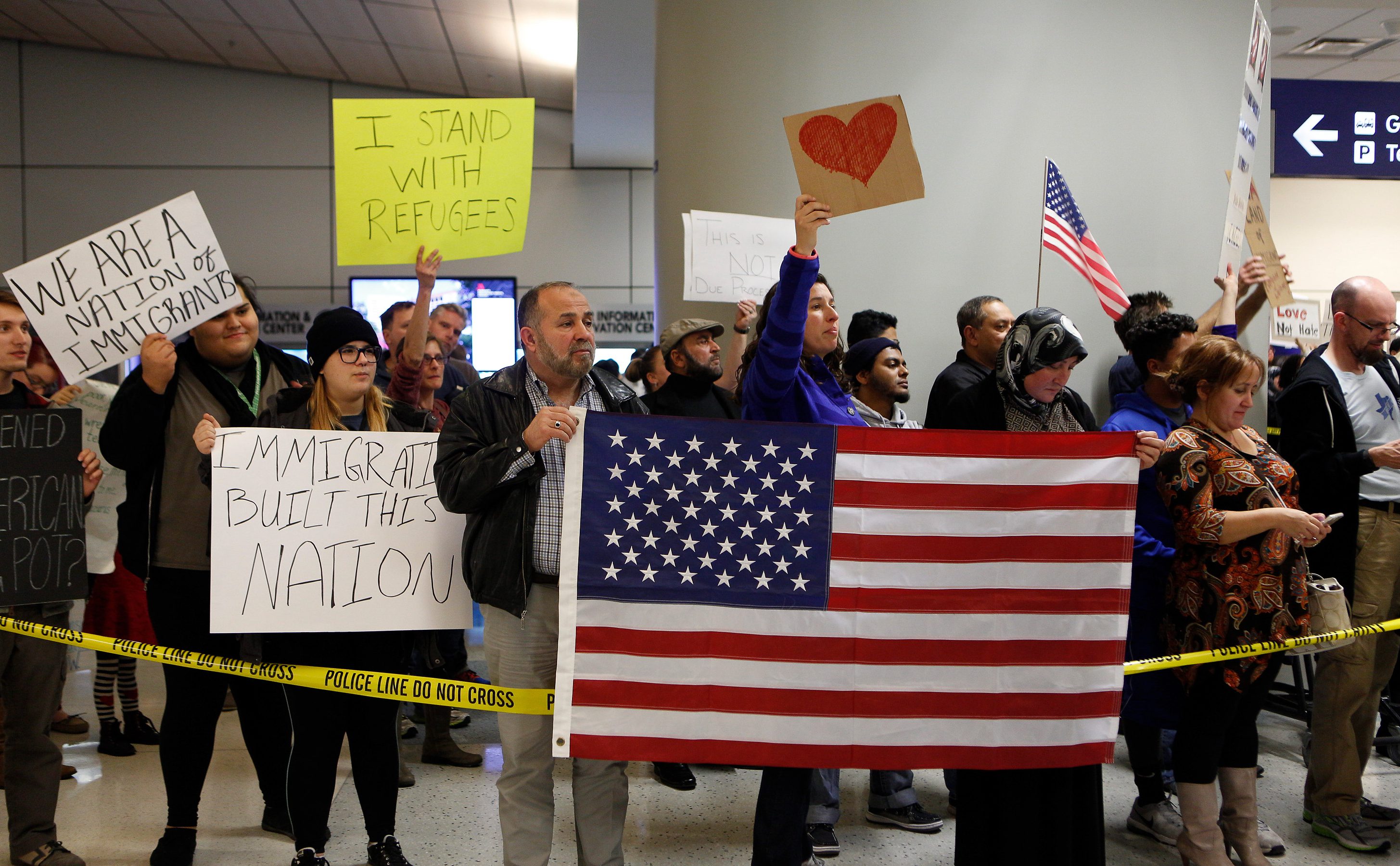 Protesters gather to denounce President Donald Trump's executive order that bans certain immigration, at Dallas-Fort Worth International Airport on January 28, 2017 in Dallas, Texas. (Getty)