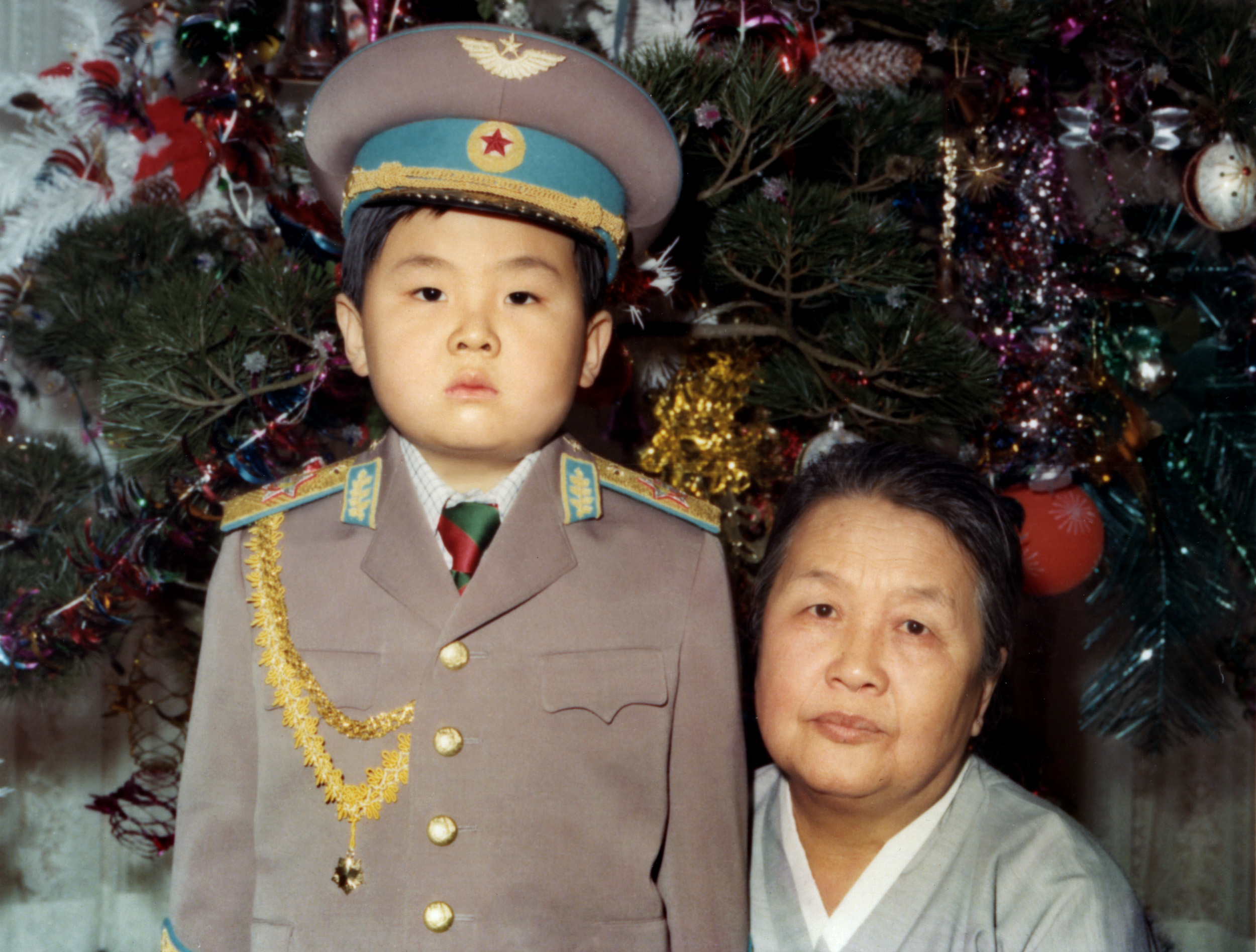 Kim Jong-Nam dressed in an army uniform poses with his maternal grandmother in January 1975 in an unknown place. (Getty) 
