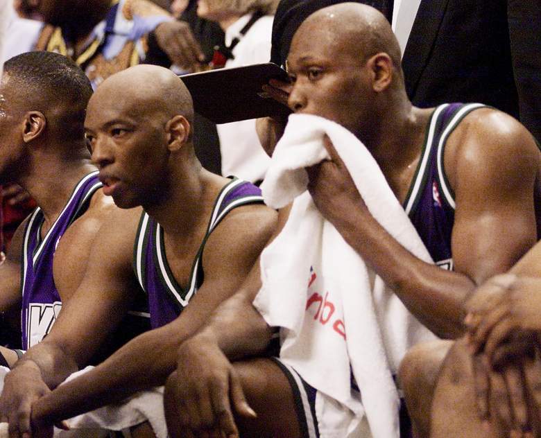 Glen Robinson, right, and Sam Cassell, left, of the Milwaukee Bucks rest on the bench during a game. (Getty)