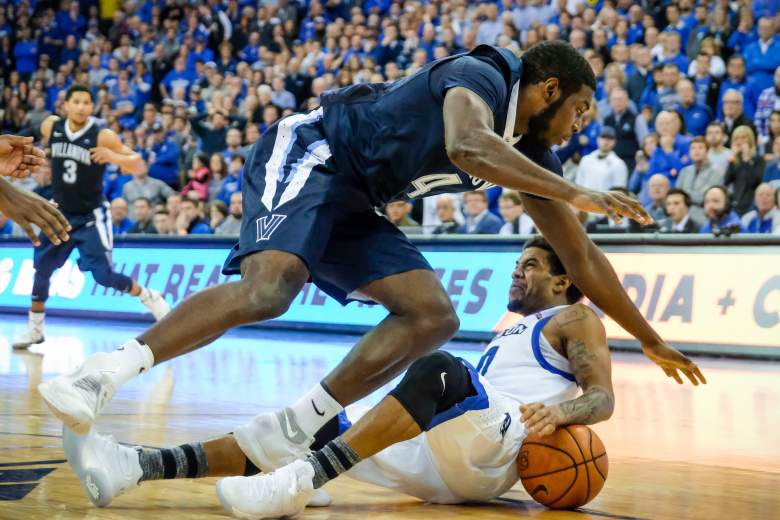 Eric Paschall of the Villanova Wildcats falls over Maurice Watson Jr. of the Creighton Bluejays during a game December 31, 2016. (Getty)