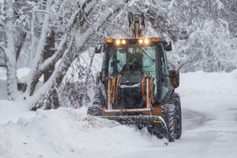 A snow plow works to widen a street during a snow storm February 13 in Lynnfield, Massachusetts. Another winter storm brought heavy snow and wind to the region.  (Getty)