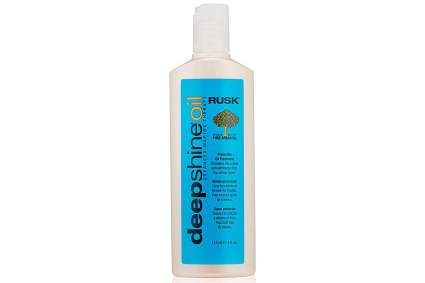 Blue bottle of RUSK protective hair oil