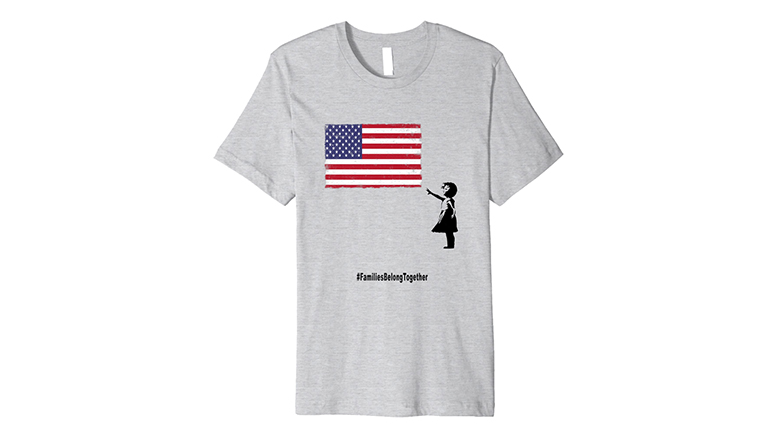 Families belong together shirt with child reaching for US flag