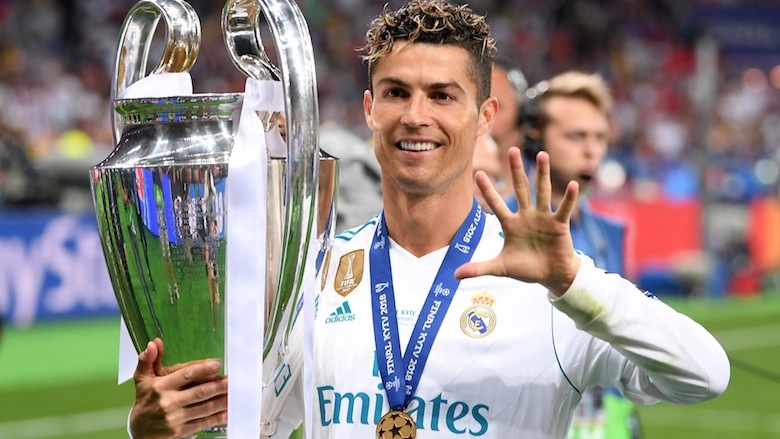 Cristiano Ronaldo poses with a trophy.