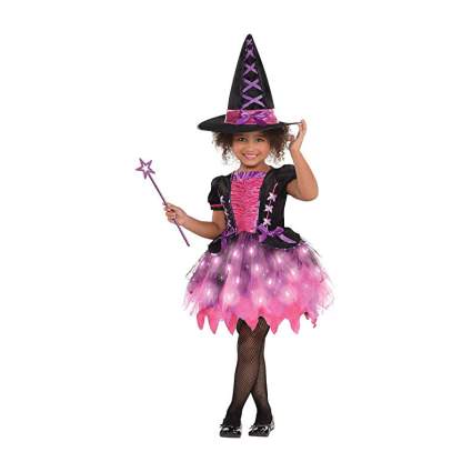 Young girl in witch costume