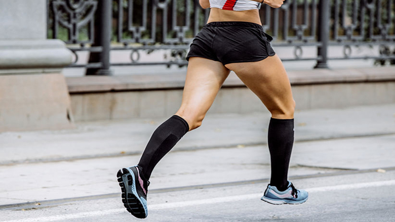 legs runner in compression calf sleeve running trail Stock Photo