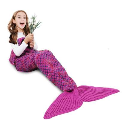 girl in a pink mermaid tail blanket