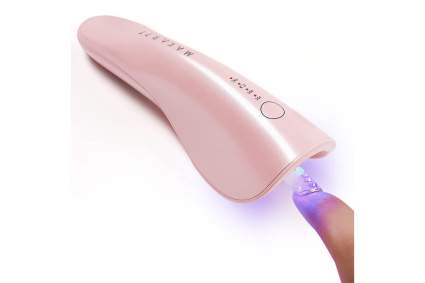 Pink wand shaped nail dryer with finger