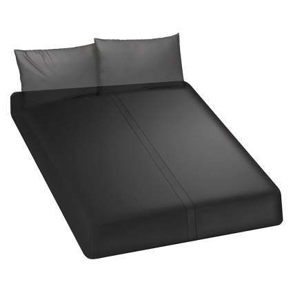 bed with black fitted sheet