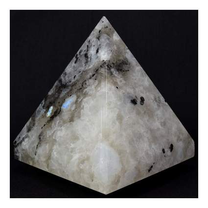 White pyramid gemstone against black