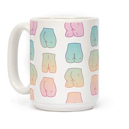 Coffee cup covered in pattern of pastel butts