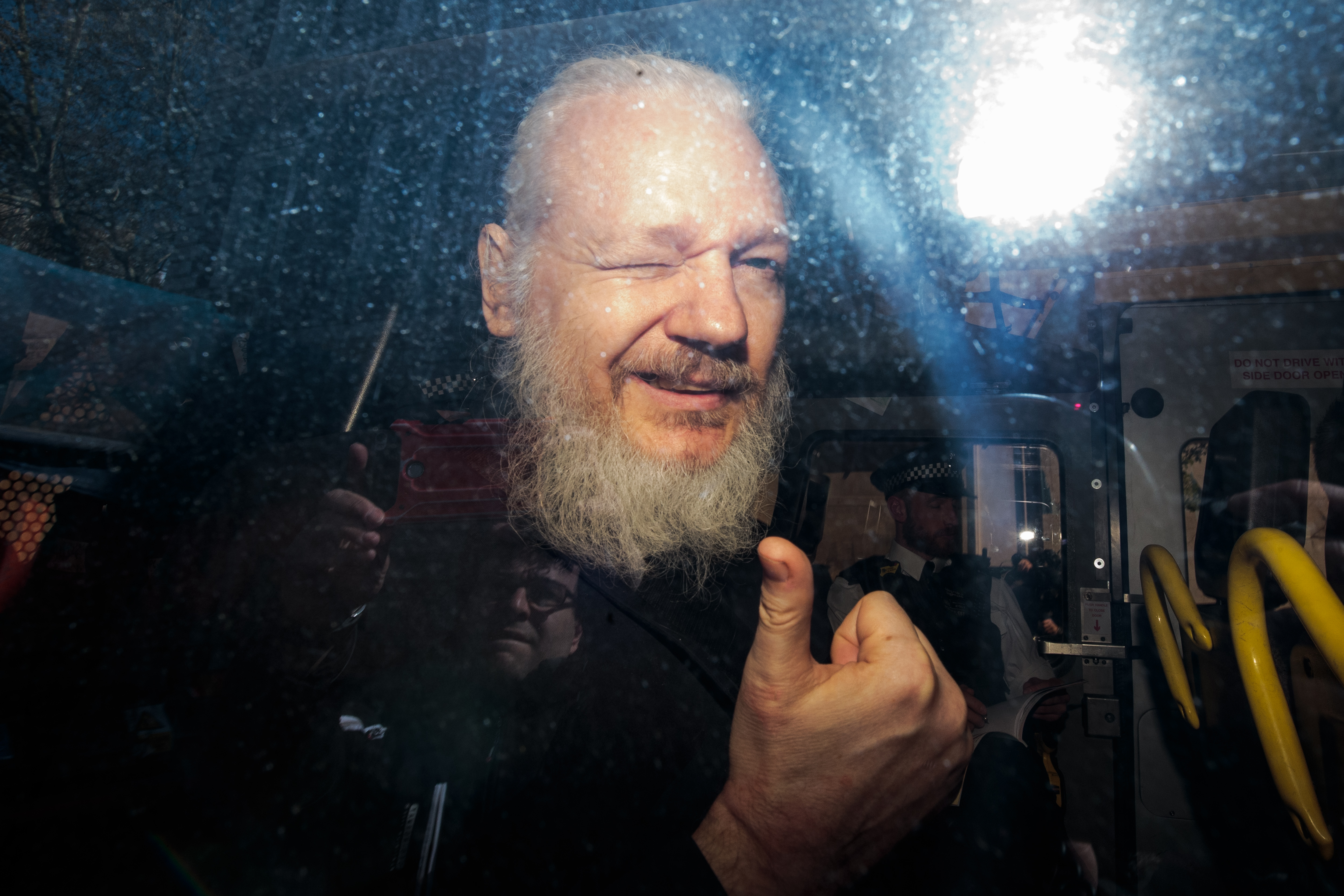 Julian Assange thumbs up