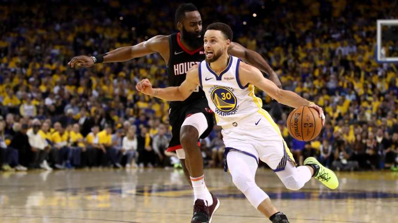 Stephen Curry #30 of the Golden State Warriors dribbles past James Harden #13 of the Houston Rockets