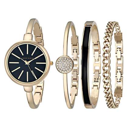 gold and black watch and bangle set