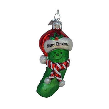 Pickle with a smiling face and Christmas hat and scarf