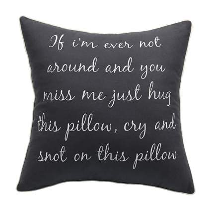 Black pillow with white text