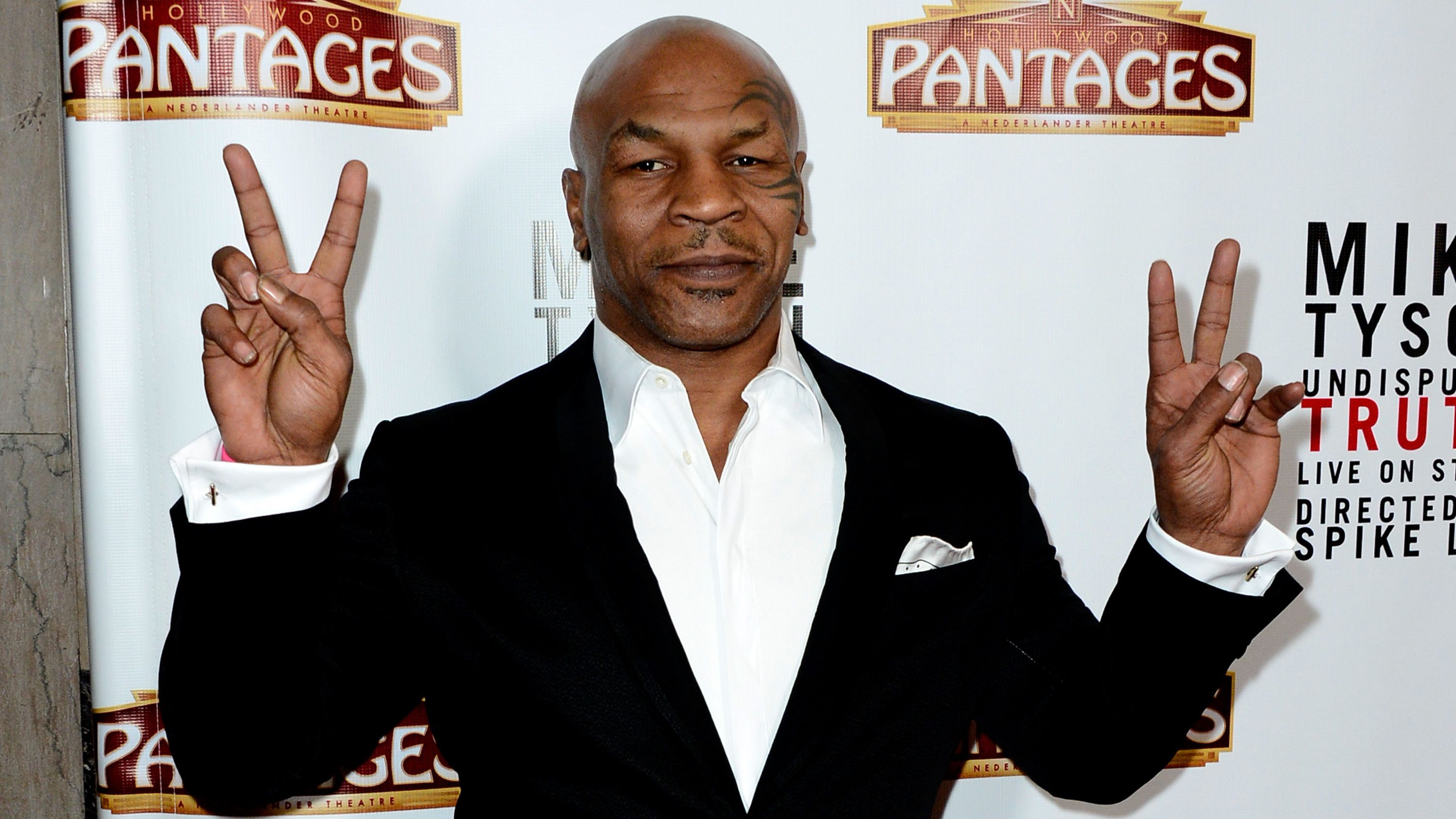 Mike Tyson Smokes Joint While Signing Boxing Contract [WATCH]