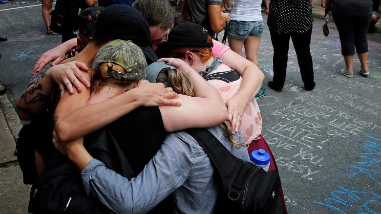 Members of the Charlottesville community and protest groups mourn near a makeshift memorial for Heather Heyer, who was killed one year ago during a deadly clash, August 12, 2018 in Charlottesville, Virginia. Charlottesville has been declared in a state of emergency by Virginia Gov. Ralph Northam as the city braces for the one year anniversary of the deadly clash between white supremacist forces and counter protesters over the potential removal of Confederate statues of Robert E. Lee and Jackson. A "Unite the Right" rally featuring some of the same groups is planned for Washington, DC.