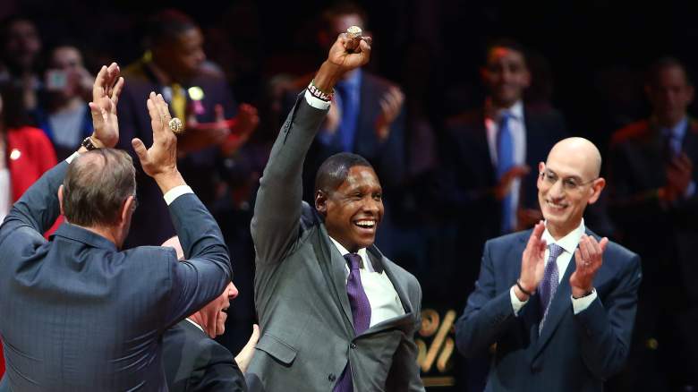 Raptors team president Masai Ujiri, at center, receives his 2019 NBA championship ring.