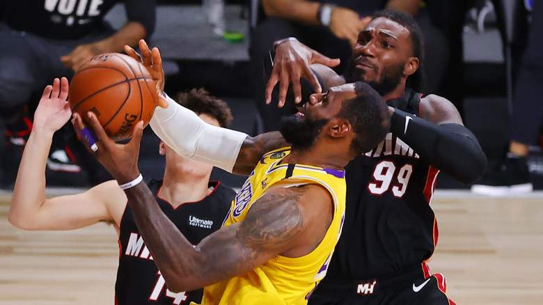 LeBron James of the Lakers takes a hit from Miami Heat forward Jae Crowder
