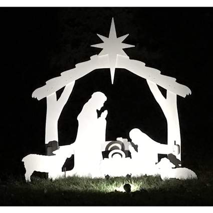 white nativity set lit up in the dark