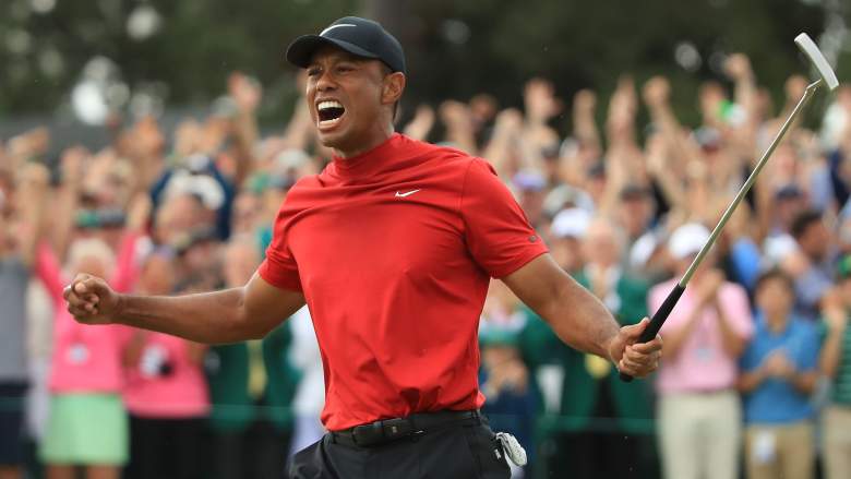 Tiger Woods (L) of the United States celebrates on the 18th green after winning the Masters at Augusta National Golf Club on April 14, 2019 in Augusta, Georgia.