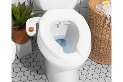 white toilet with bidet with a wooden knob
