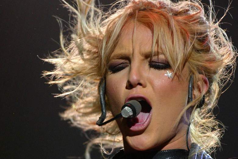 Britney Spears singing into a headset microphone.