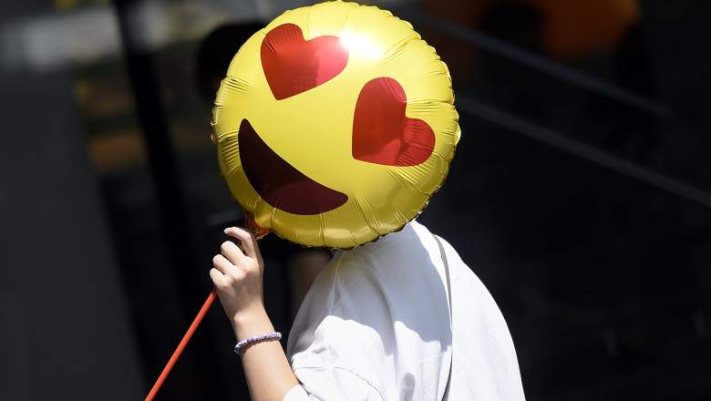 A woman holds a balloon as she walks past a store on Valentine's Day