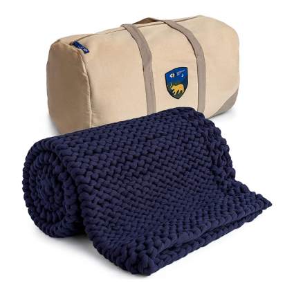 dark blue chunky knit blanket with bag