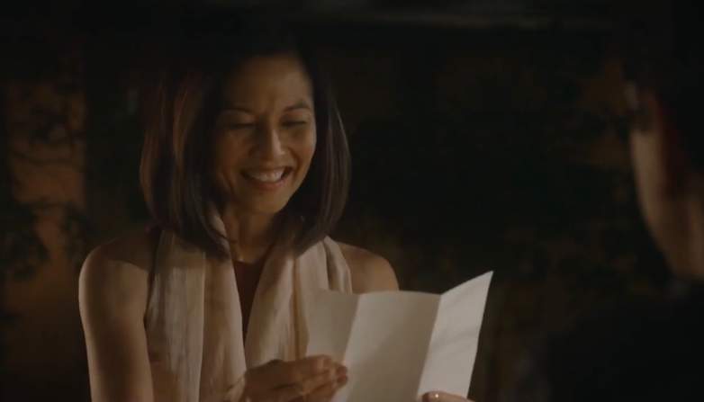 Kumiko (Tamlyn Tomita) reads Miyagi's letter to Daniel (Ralph Macchio) in Cobra Kai.