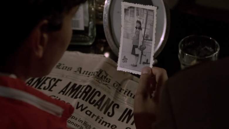 Daniel (Ralph Macchio) looks at a picture of Mr. Miyagi's wife in The Karate Kid.