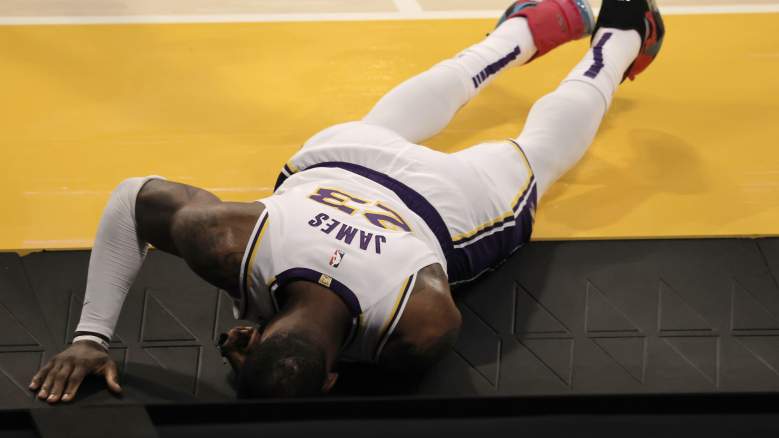 LeBron James of Lakers reacts after injuring his ankle against the Hawks Saturday night.