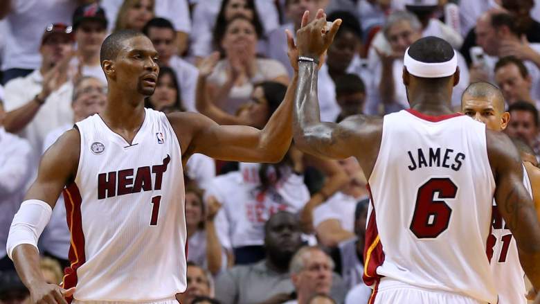 LeBron James congratulates Dwyane Wade on the Heat retiring his jersey