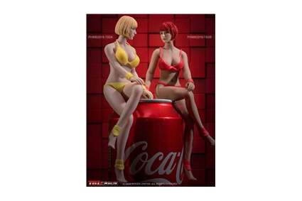 Two female silicone dolls in bikinis sitting on a Coke can