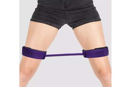Purple thigh cuffs with a spreading rod