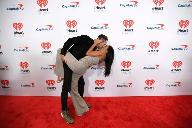 Zac Clark and Tayshia Adams kiss on the red carpet.