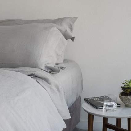 Bed with grey linen sheets
