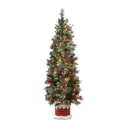 decorated fake Christmas tree with faux brick base