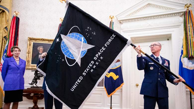 Chief Master Sgt. Roger Towberman (R), Space Force and Command Senior Enlisted Leader and CMSgt Roger Towberman (L), with Secretary of the Air Force Barbara Barrett present US President Donald Trump with the official flag of the United States Space Force in the Oval Office of the White House
