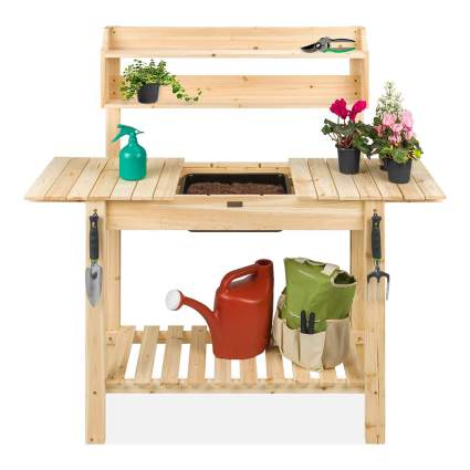 Light colored wooden potting bench with watering can