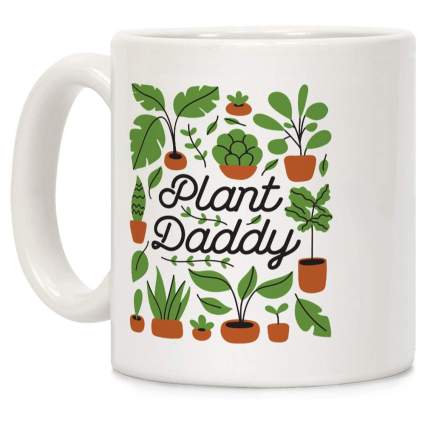 White coffee mug with plant images and text "plant daddy"
