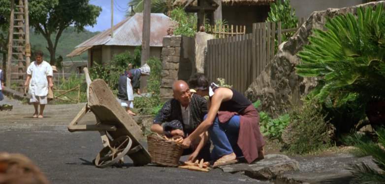 Daniel LaRusso helps a villager in "The Karate Kid Part II"