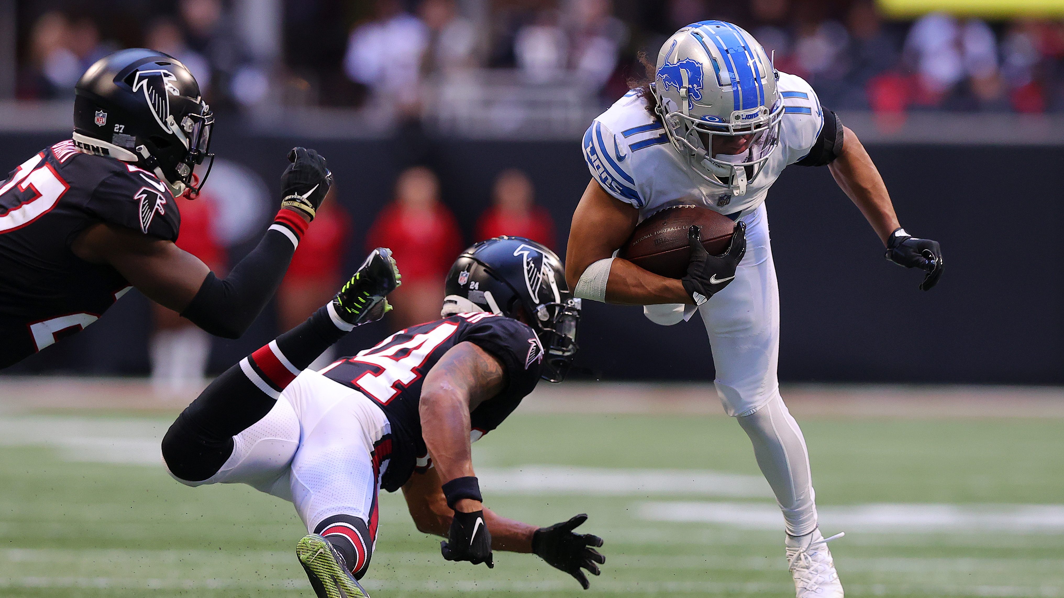 Detroit Lions wide receiver Kalif Raymond (11) is tackled by