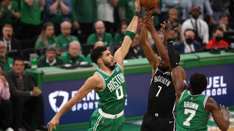 Jayson Tatum and Jaylen Brown of the Boston Celtics guarding Kevin Durant of the Brooklyn Nets.