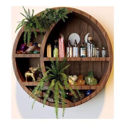 Wooden crescent moon shaped round wooden shelf with crystsals and plants