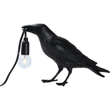 black crow lamp holding a lightbulb